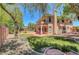 Lush backyard with grassy area, mature trees, and a covered patio, perfect for outdoor living at 229 N Buteo Woods Ln, Las Vegas, NV 89144