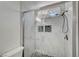 Elegant, renovated bathroom with stylish tile, glass shower door, and modern fixtures offers a spa-like experience at 229 N Buteo Woods Ln, Las Vegas, NV 89144