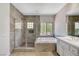 Contemporary bathroom showcasing a glass shower and a soaking tub at 229 N Buteo Woods Ln, Las Vegas, NV 89144