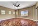 Spacious bedroom with hardwood floors, neutral walls, ceiling fan, and natural light at 229 N Buteo Woods Ln, Las Vegas, NV 89144