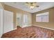 Relaxing bedroom with a ceiling fan, natural light, closet, and attached bathroom for convenience at 229 N Buteo Woods Ln, Las Vegas, NV 89144