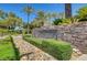 A stone sign at the entrance to Talon Pointe is surrounded by desert landscaping at 229 N Buteo Woods Ln, Las Vegas, NV 89144