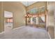 Bright dining room with stone tile floors, chandelier, and large windows with decorative curtains overlooking the backyard at 229 N Buteo Woods Ln, Las Vegas, NV 89144