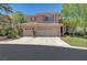 Charming two-story home with a three-car garage, desert landscaping, and a well-maintained lawn at 229 N Buteo Woods Ln, Las Vegas, NV 89144