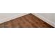 Close-up of wood-look flooring with white baseboards, showcasing the finish and pattern at 229 N Buteo Woods Ln, Las Vegas, NV 89144