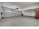 Large garage boasts three doors, epoxy floors and ample space for vehicles and storage at 229 N Buteo Woods Ln, Las Vegas, NV 89144