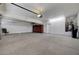 Spacious three-car garage features epoxy floors, storage cabinets and water heater at 229 N Buteo Woods Ln, Las Vegas, NV 89144