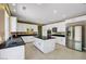 Kitchen features stainless steel appliances, an island, and white cabinetry at 229 N Buteo Woods Ln, Las Vegas, NV 89144