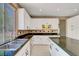 Bright kitchen with granite counters, backsplash, stainless steel appliances, and white cabinets at 229 N Buteo Woods Ln, Las Vegas, NV 89144