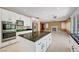 Kitchen with stainless appliances, island, and open concept design to the living room at 229 N Buteo Woods Ln, Las Vegas, NV 89144