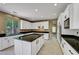 Spacious kitchen with granite countertops, modern appliances, and a central island provides plenty of room for cooking at 229 N Buteo Woods Ln, Las Vegas, NV 89144