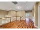 Well-lit upstairs landing with hardwood floors and railing overlooking the foyer at 229 N Buteo Woods Ln, Las Vegas, NV 89144