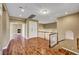 Upstairs landing featuring wood floors, a built-in cabinet, and views of the home's interior at 229 N Buteo Woods Ln, Las Vegas, NV 89144