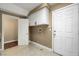 Functional laundry room with storage cabinets and utility sink for easy cleaning and organization at 229 N Buteo Woods Ln, Las Vegas, NV 89144