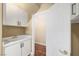 Convenient laundry room with utility sink and built-in cabinets for efficient household tasks and storage solutions at 229 N Buteo Woods Ln, Las Vegas, NV 89144