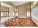 Spacious living room featuring hardwood and tile floors, high ceilings, and large windows with decorative curtains at 229 N Buteo Woods Ln, Las Vegas, NV 89144
