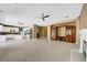 An open living space with fireplace, built-in cabinetry, and a view to the kitchen at 229 N Buteo Woods Ln, Las Vegas, NV 89144