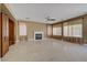 Spacious living room with fireplace, ceiling fan, and bright natural light at 229 N Buteo Woods Ln, Las Vegas, NV 89144