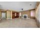 Living room with travertine floors, fireplace, and a large built-in cabinet at 229 N Buteo Woods Ln, Las Vegas, NV 89144