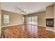 Bright living room with wood floors, fireplace, balcony access, and natural light at 229 N Buteo Woods Ln, Las Vegas, NV 89144