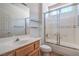 Bathroom featuring a vanity with one sink, a mirror, and a glass enclosed tub shower at 2413 Rockford St, Las Vegas, NV 89134