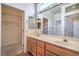 Bathroom featuring double sinks, a large mirror, and a door leading to the walk in closet at 2413 Rockford St, Las Vegas, NV 89134