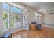 Dining area with hardwood floors, chandelier, and big windows offering views of the backyard at 2413 Rockford St, Las Vegas, NV 89134