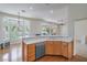 Kitchen area with ample counter space, wooden cabinets, dishwasher and view to dining nook at 2413 Rockford St, Las Vegas, NV 89134