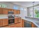 Well-lit kitchen with stainless steel appliances, wooden cabinets, and adjacent breakfast nook area at 2413 Rockford St, Las Vegas, NV 89134