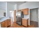 Functional kitchen featuring wood cabinets, stainless steel appliances, and access to adjacent rooms at 2413 Rockford St, Las Vegas, NV 89134