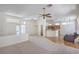 Bright, open-concept living area with wood and carpet flooring, seamlessly connecting to the kitchen at 2413 Rockford St, Las Vegas, NV 89134
