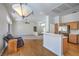 Open-concept living space features hardwood floors, kitchen bar, and a view of the living room at 2413 Rockford St, Las Vegas, NV 89134