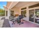 Relaxing covered patio with seating and a grill, ideal for enjoying the backyard views at 2413 Rockford St, Las Vegas, NV 89134