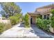 This backyard features a covered patio and lush landscaping at 2528 Huber Heights Dr, Las Vegas, NV 89128