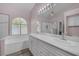 Elegant bathroom with double sinks, a vanity, decorative lighting, and a luxurious tiled shower at 2528 Huber Heights Dr, Las Vegas, NV 89128
