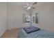 Well-lit bedroom with hardwood laminate floors, a door, and natural light from a pair of windows at 2528 Huber Heights Dr, Las Vegas, NV 89128