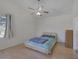 Bright bedroom with ceiling fan, hardwood laminate flooring, and window with lots of natural light at 2528 Huber Heights Dr, Las Vegas, NV 89128
