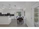 Bright dining area connected to kitchen featuring large windows and light wood floors at 2528 Huber Heights Dr, Las Vegas, NV 89128