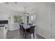 Dining area with a light wood floor, large windows, and modern chandelier at 2528 Huber Heights Dr, Las Vegas, NV 89128