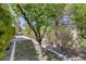Landscaped front yard featuring desert foliage and decorative rock, with a concrete path leading to the home at 2528 Huber Heights Dr, Las Vegas, NV 89128