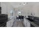 Bright kitchen and dining area with granite countertops, modern appliances, and large windows at 2528 Huber Heights Dr, Las Vegas, NV 89128