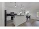 Bright eat-in kitchen with white cabinets, a breakfast bar, and dark countertops at 2528 Huber Heights Dr, Las Vegas, NV 89128