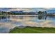 Scenic lake view with calm water reflecting the sky and distant mountains, showcasing a tranquil setting at 2528 Huber Heights Dr, Las Vegas, NV 89128