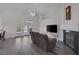 Open living room featuring a fireplace, French doors, and light wood floors at 2528 Huber Heights Dr, Las Vegas, NV 89128