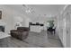 Open-concept floor plan with updated kitchen, dining area, and sliding glass doors with hardwood laminate at 2528 Huber Heights Dr, Las Vegas, NV 89128
