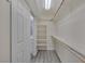 Walk-in closet featuring ample shelving and railing for storage with adjoining door to the bathroom at 2528 Huber Heights Dr, Las Vegas, NV 89128