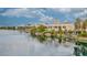 Beautiful waterfront view of lakeside properties reflecting on the serene lake surface with lush landscaping at 2528 Huber Heights Dr, Las Vegas, NV 89128