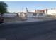 View of a single-story home with a chimney and a chain link fence at 2645 Cedar Ave, Las Vegas, NV 89101