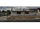 Exterior shot of a single-story home behind a chain link fence on an overcast day at 2645 Cedar Ave, Las Vegas, NV 89101