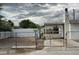 Image of the front yard behind a chain link fence and a partial view of a single-story home at 2645 Cedar Ave, Las Vegas, NV 89101